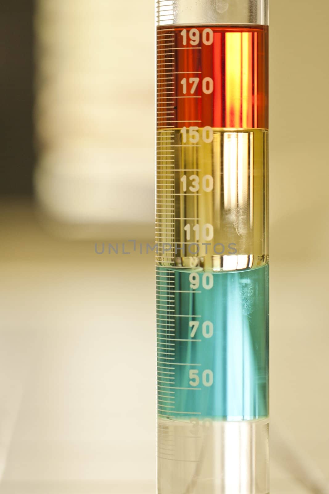 Close up view of a test tube with some different liquid solutions.