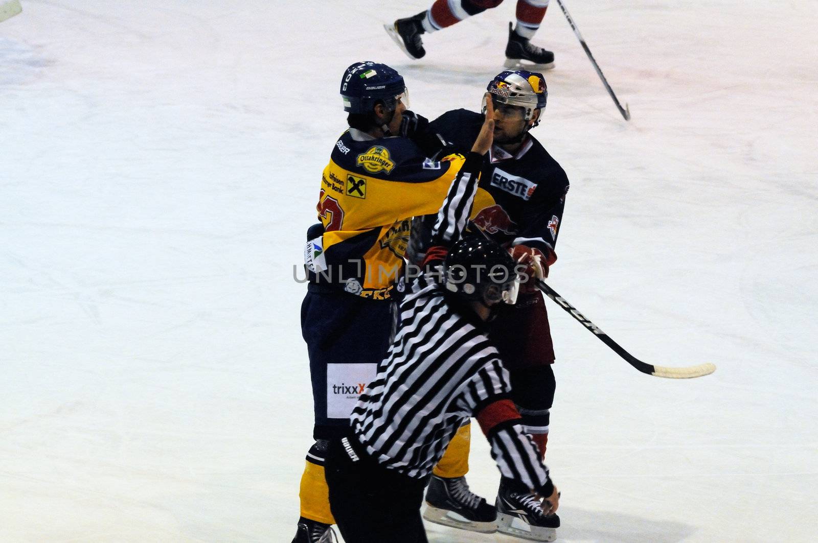 ZELL AM SEE, AUSTRIA - DECEMBER 7: Austrian National League. Referee signaling a penalty as things get nasty. Game EK Zell am See vs. Red Bulls Salzburg (Result 4-6) on December 7, 2010, at hockey rink of Zell am See