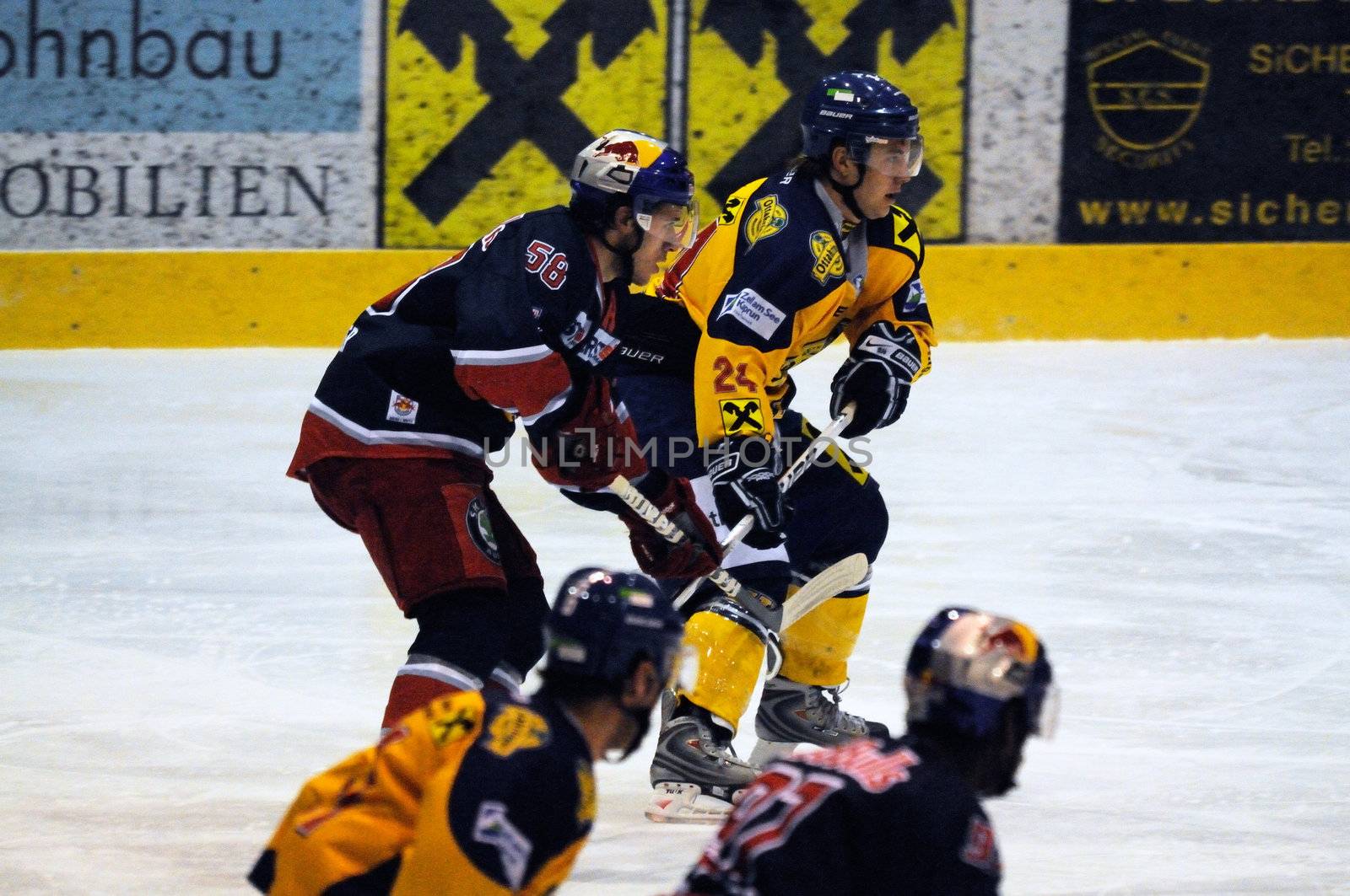 ZELL AM SEE, AUSTRIA - DECEMBER 7: Austrian National League. Battle for the puck in the neutral zone. Game EK Zell am See vs. Red Bulls Salzburg (Result 4-6) on December 7, 2010, at hockey rink of Zell am See