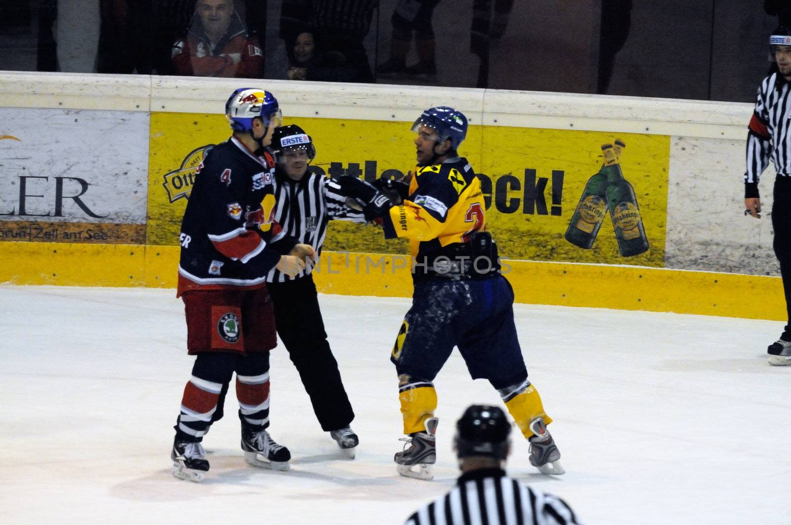 ZELL AM SEE, AUSTRIA - DECEMBER 7: Austrian National League. Referees stopping fight between Schernthaner and Mitterdorfer. Game EK Zell am See vs. Red Bulls Salzburg (Result 4-6) on December 7, 2010, at hockey rink of Zell am See