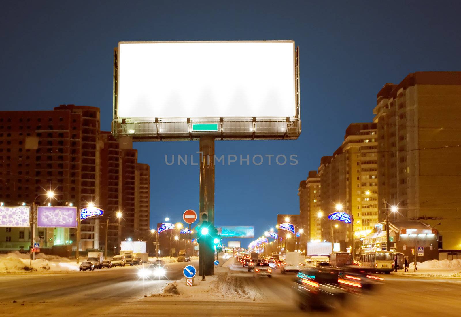 Big white billboard on night street of Sankt-Peterburg