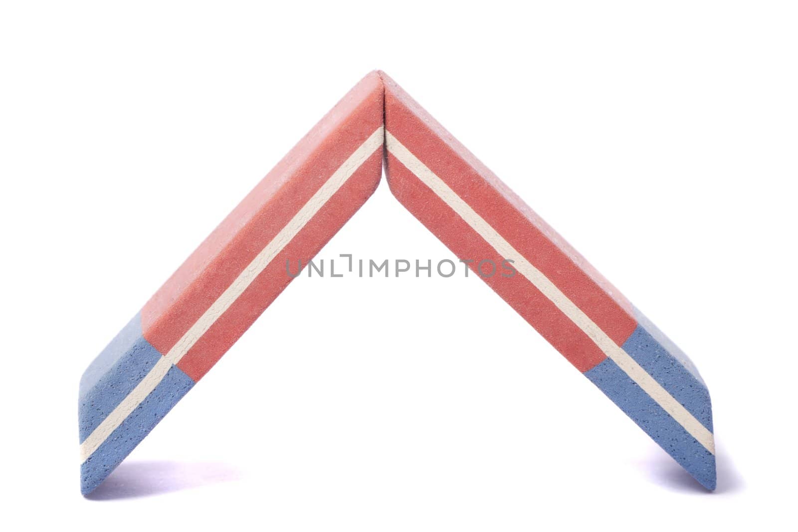 Close up view of a blue and red eraser isolated on a white background.