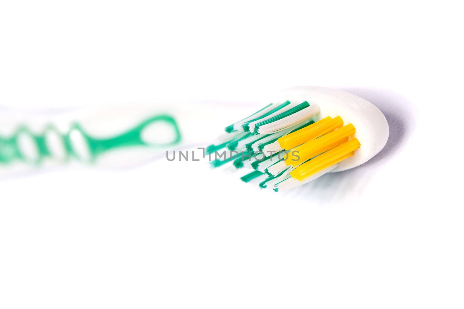 Close up view of a tooth brush isolated on a white background.