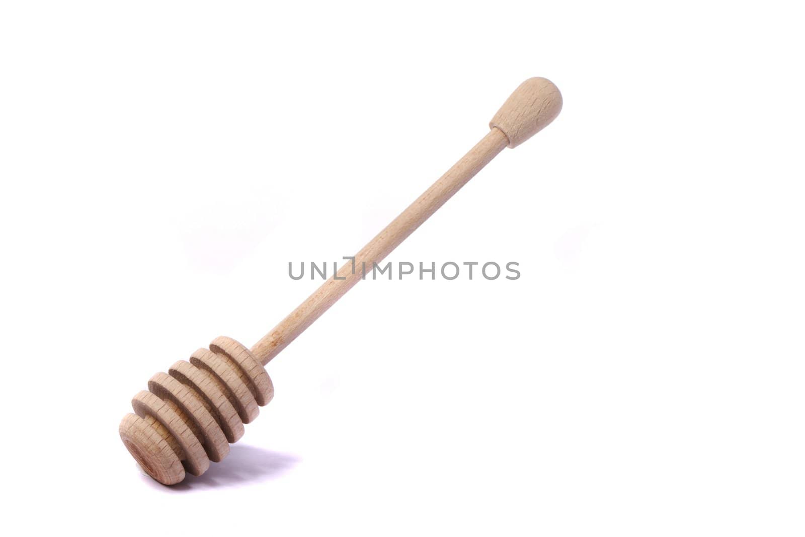 Close up view of a honey dipper utensil isolated on a white background.