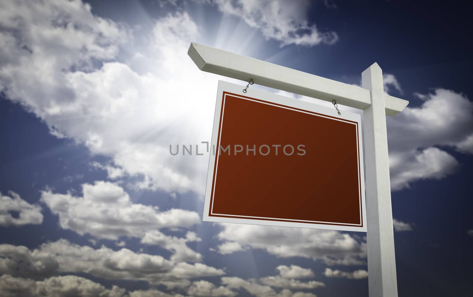 Blank Red Real Estate Sign Over Clouds and Sky Ready For Your Own Message.