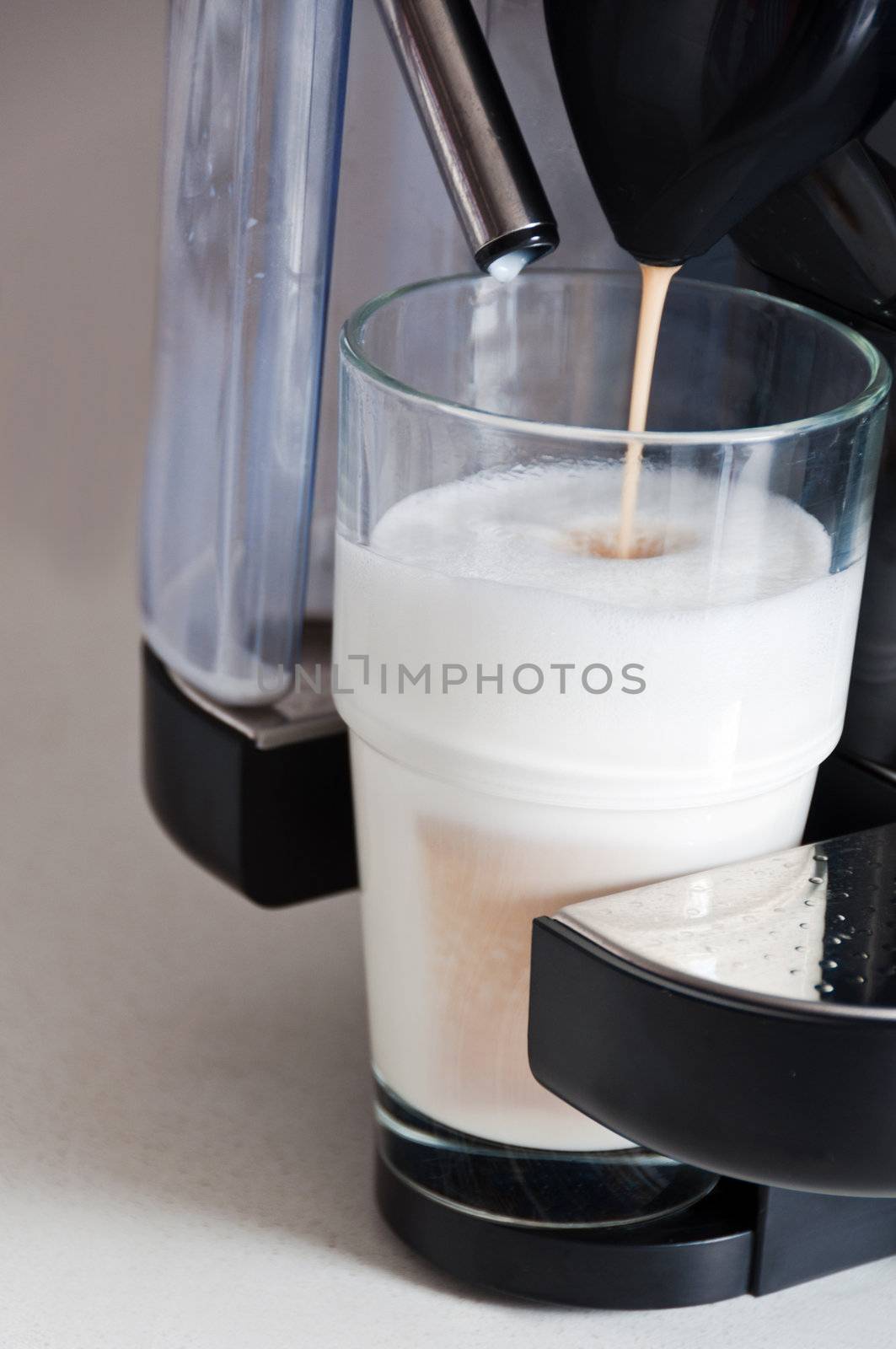 making a nice latte. cofee being poured on steamed milk