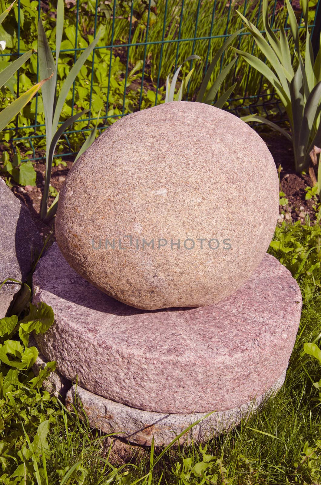 Several mill stones on top of one another and stone on top.