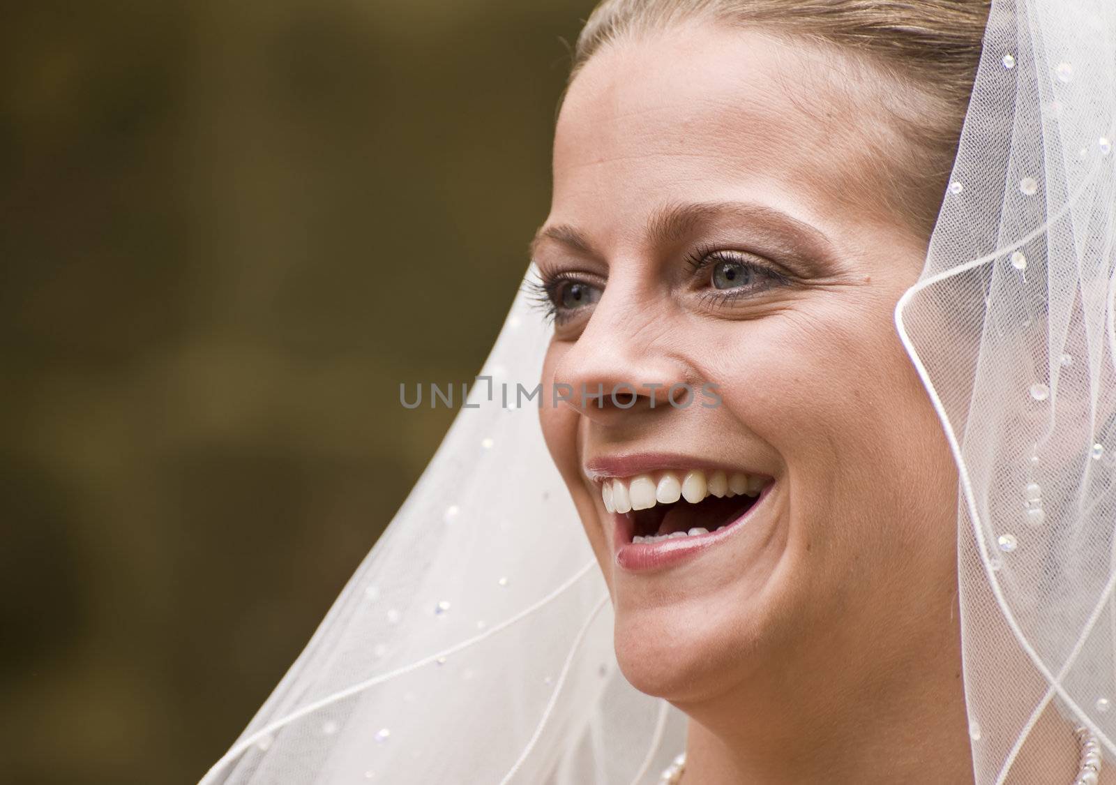 Close up portrait of beautiful young bride smiling nautrally by Veneratio