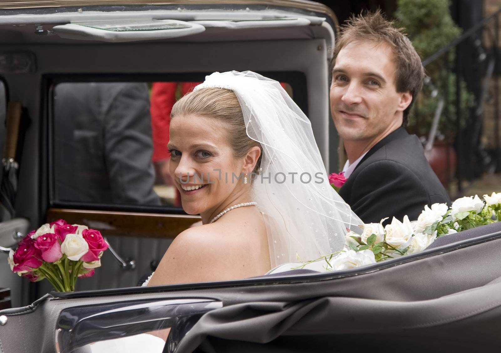 Bride and groom arrive at reception in vintage wedding car by Veneratio