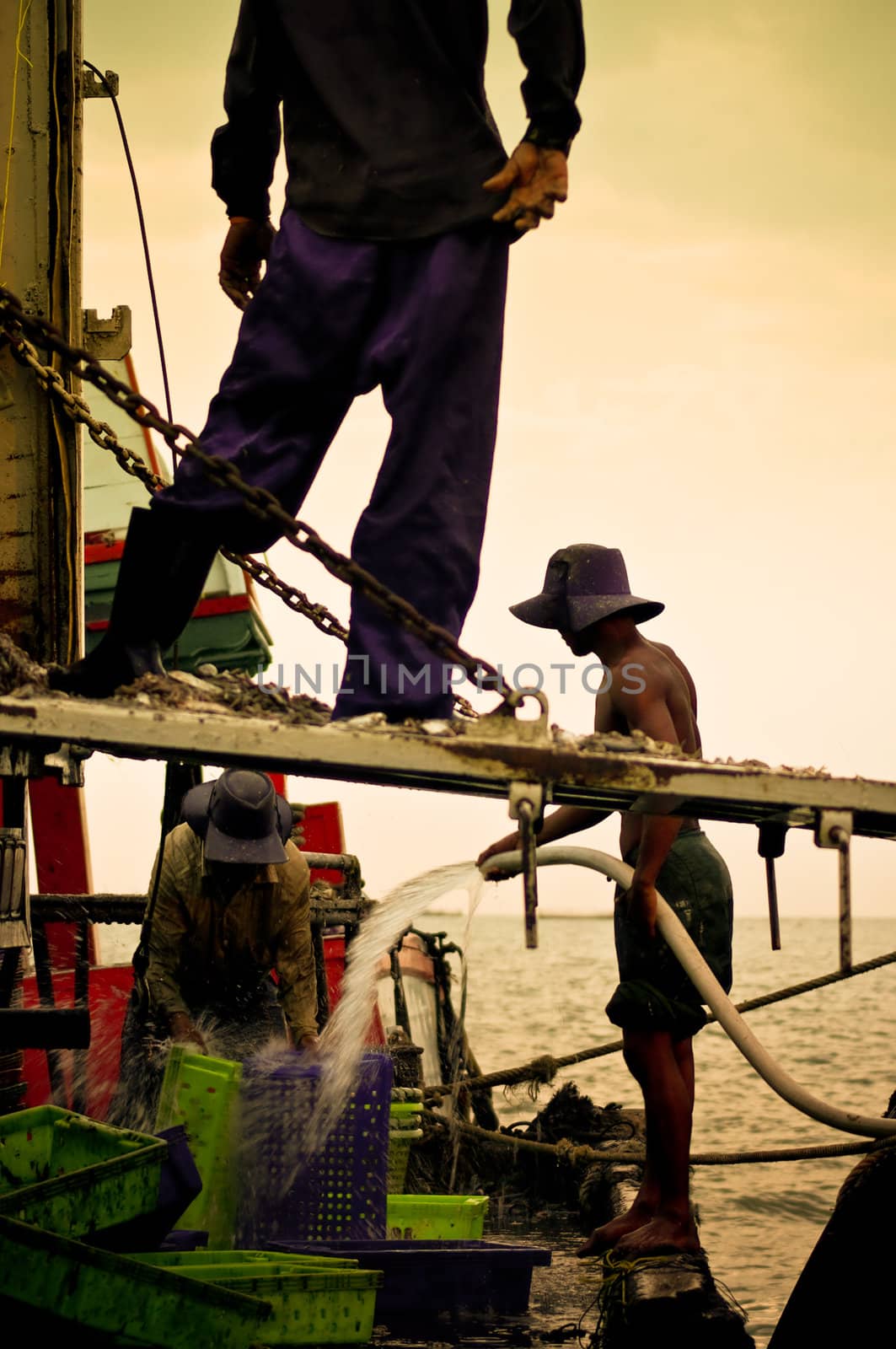 Fisherman washing the fish basket, Siracha, Choburi, Thailand