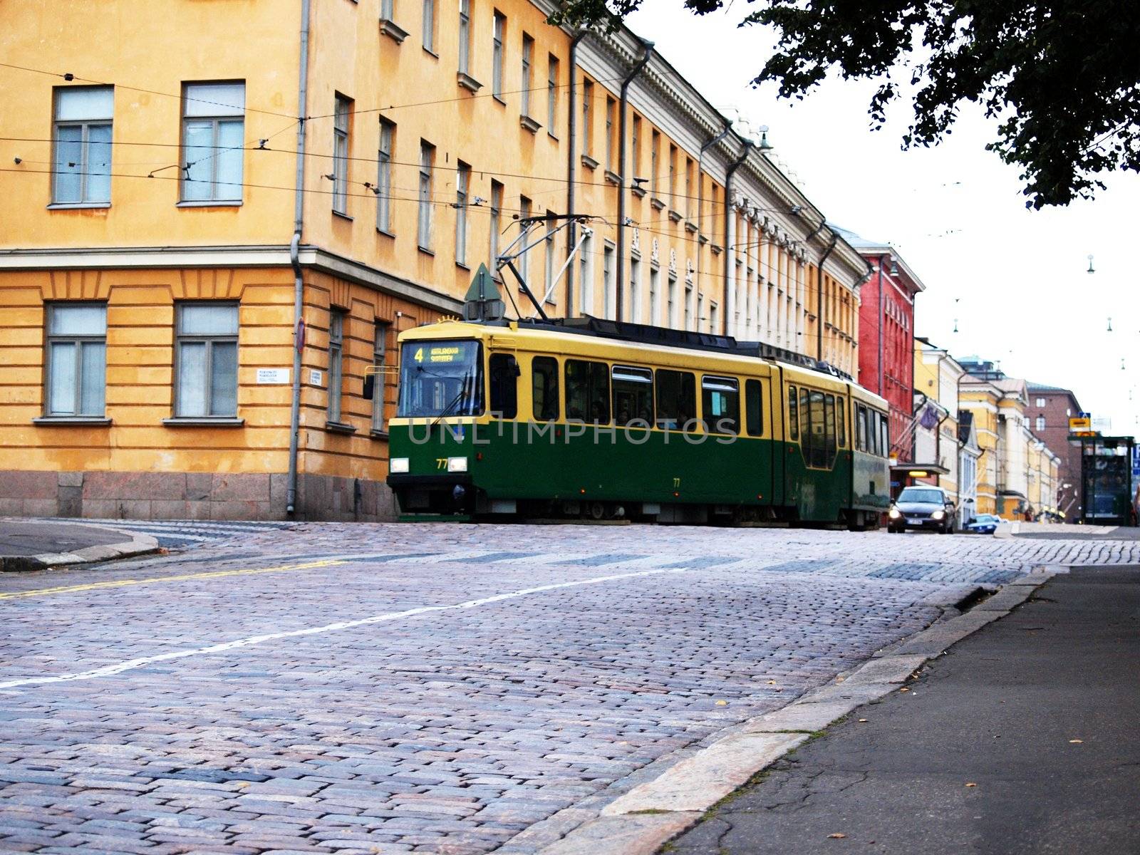 Green old tram in city center of Helsinki Finland