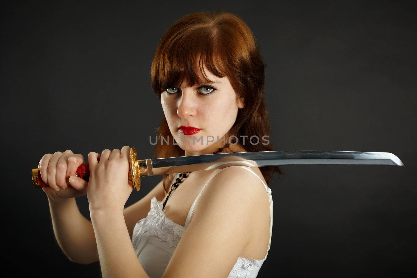 Young woman holding what are ready Japanese sword