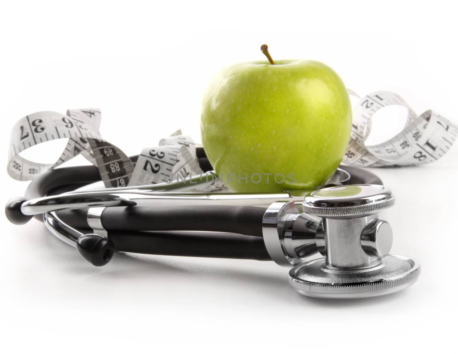Green apple with stethoscope on white by Sandralise