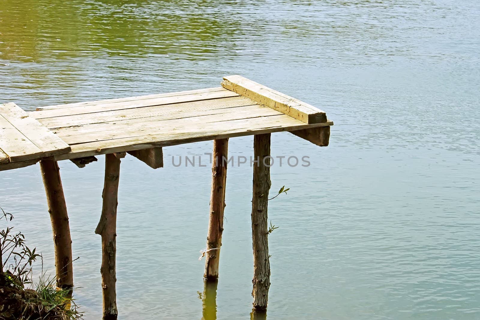 Handmade wooden springboard at the village pond