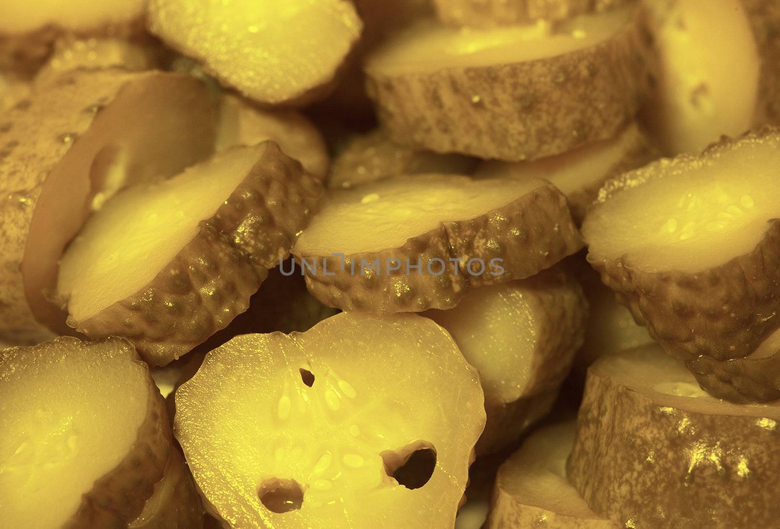 Close up background - sliced pickled cucumbers - cornichons