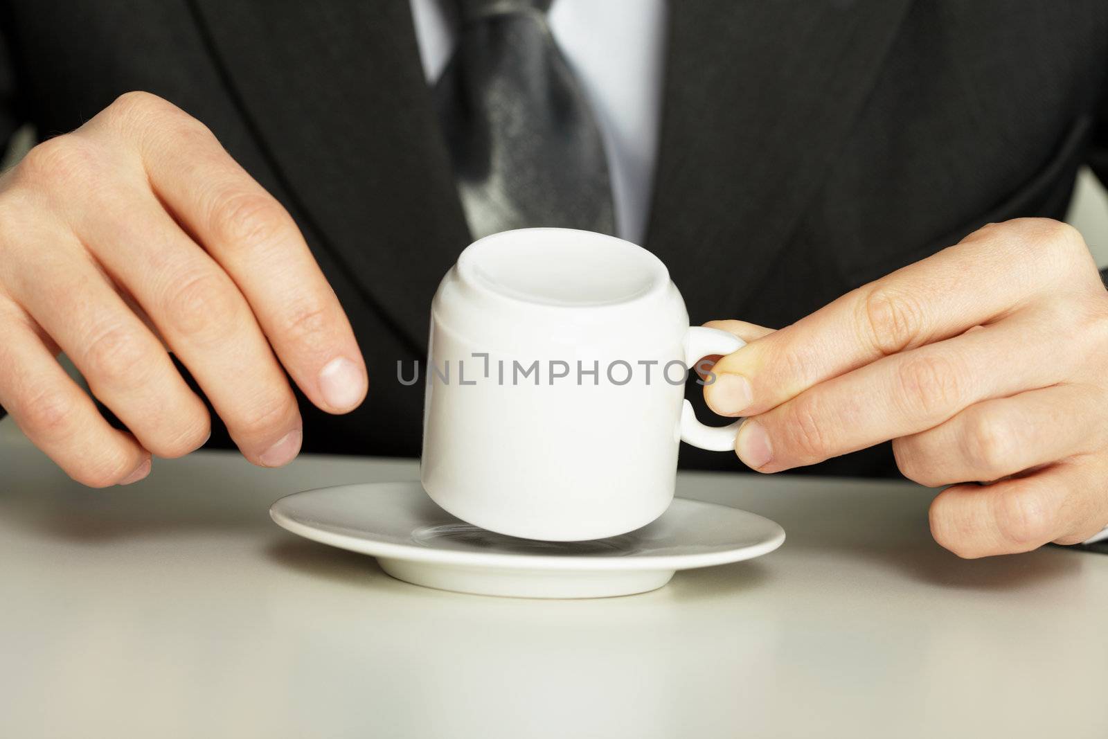Businessman guesses on coffee grounds close up