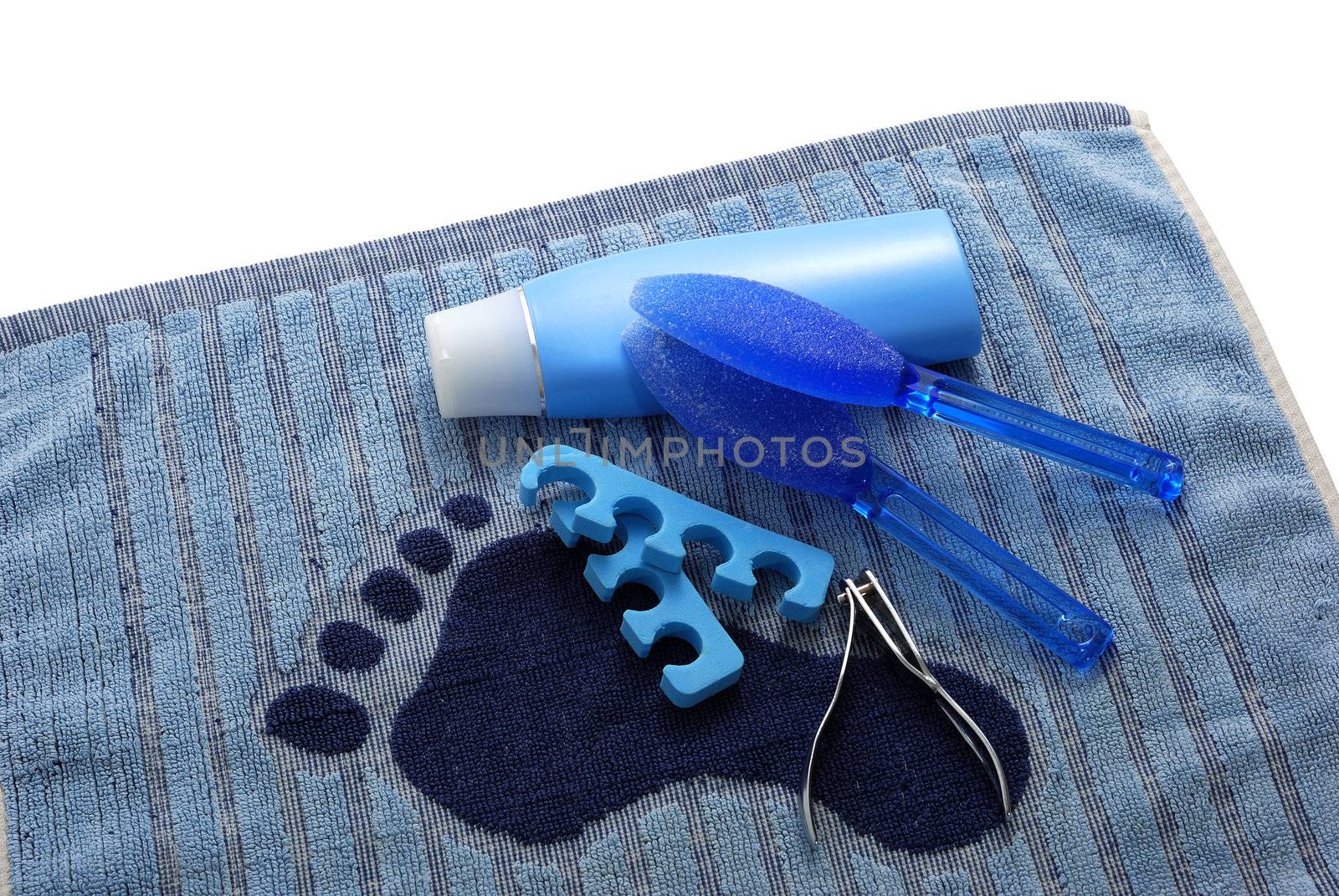 Blue foot SPA on towel with footprint with cream and nails clipper