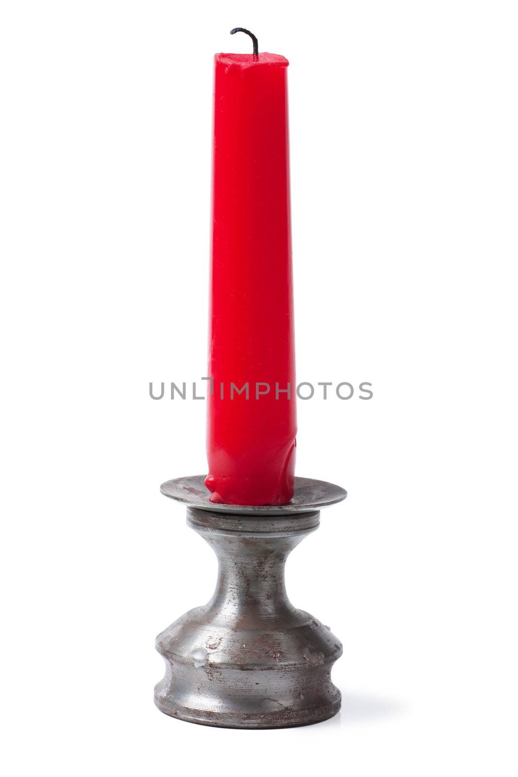 An unlit red candle isolated on the white