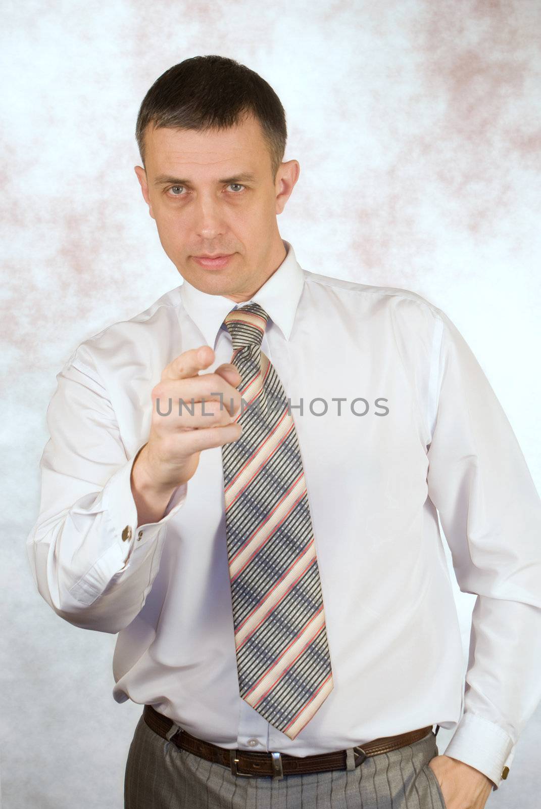 Portrait of the serious businessman on an abstract background