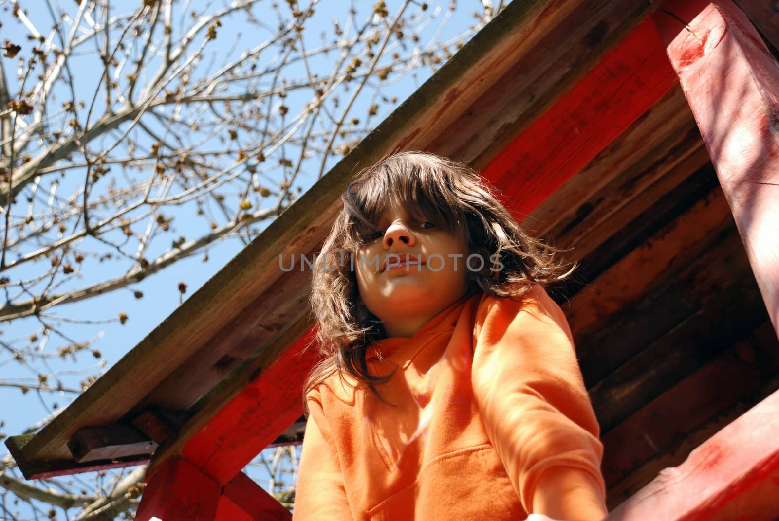 cheerful smiling caucasian girl portrait on playground on sunlight