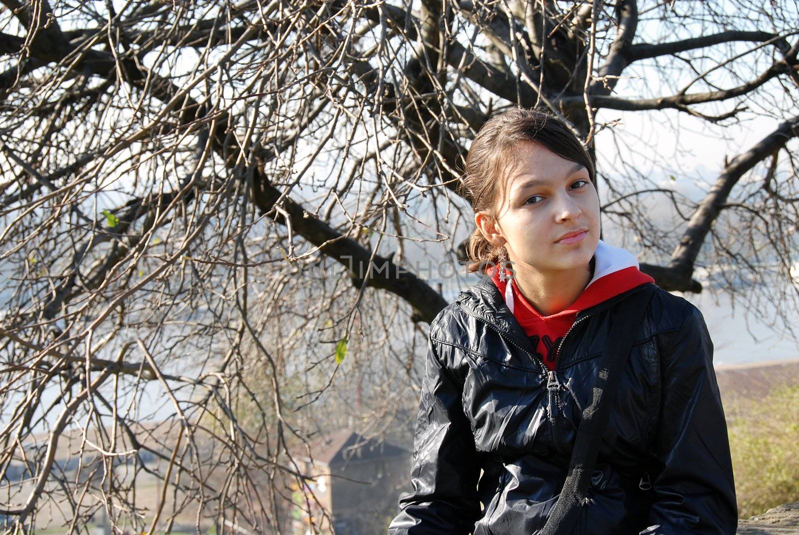 beautiful teenage girl portrait in black jacket outdoor