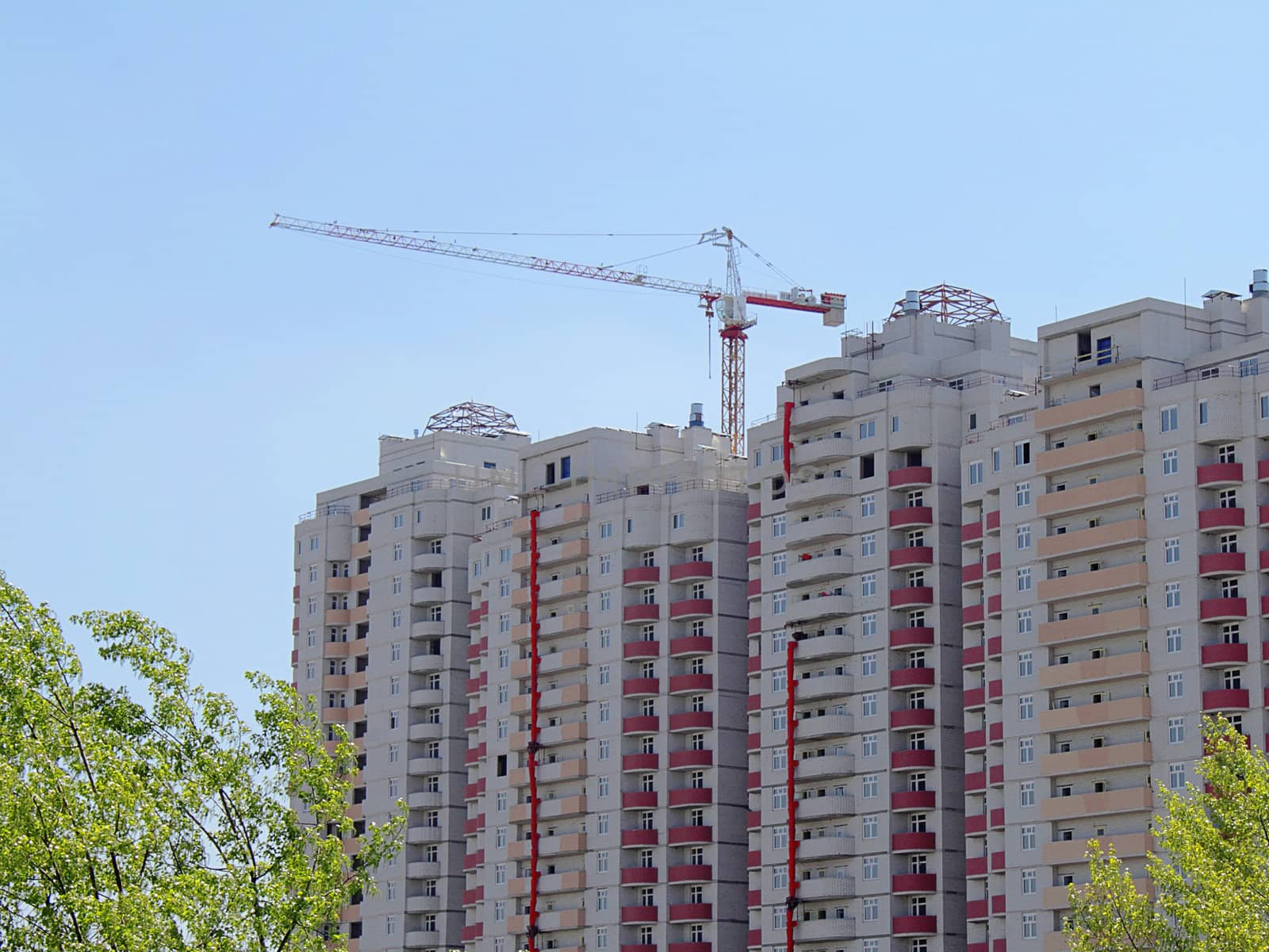 Apartment house under construction with a building crane