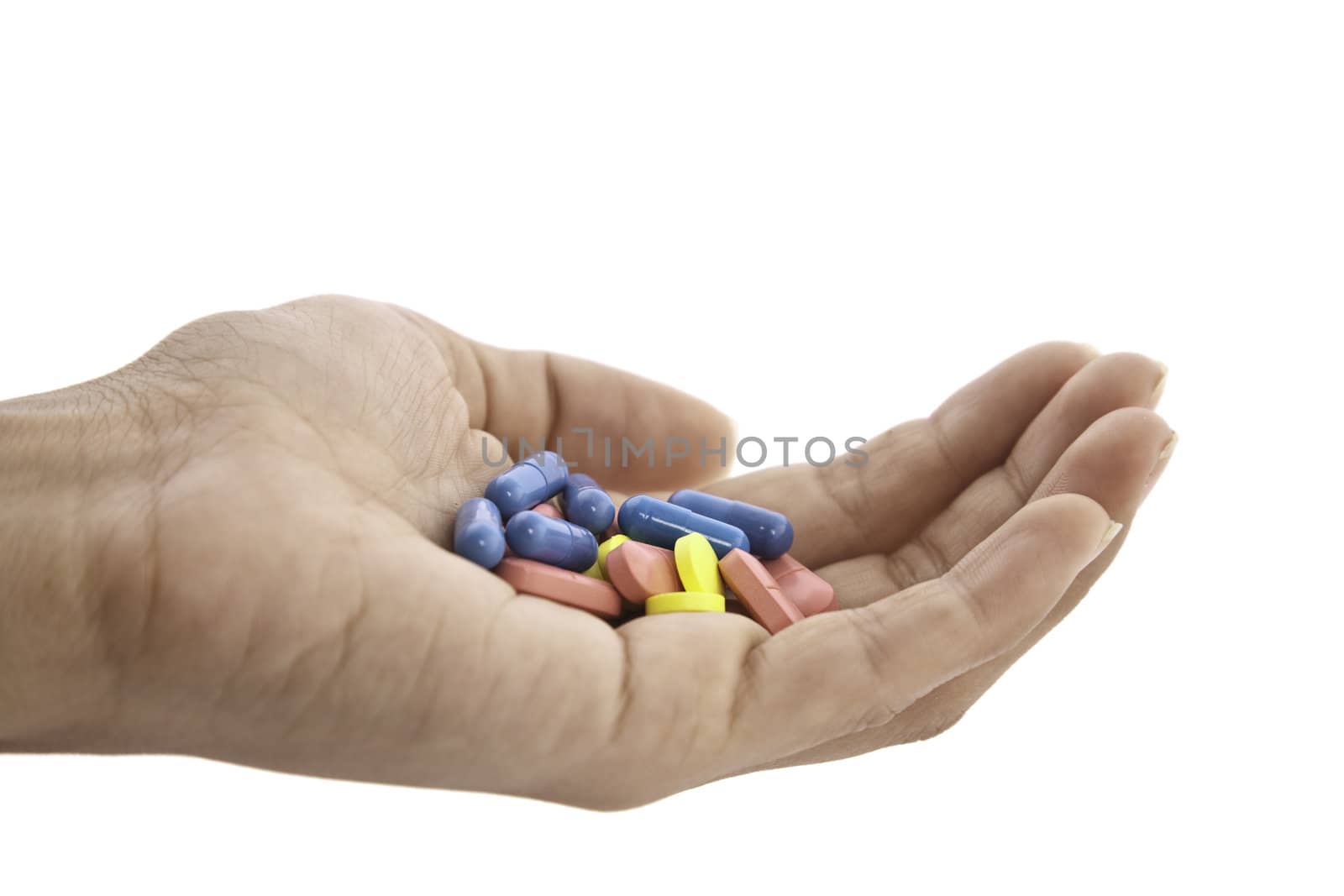 pills in hand isolated on white background