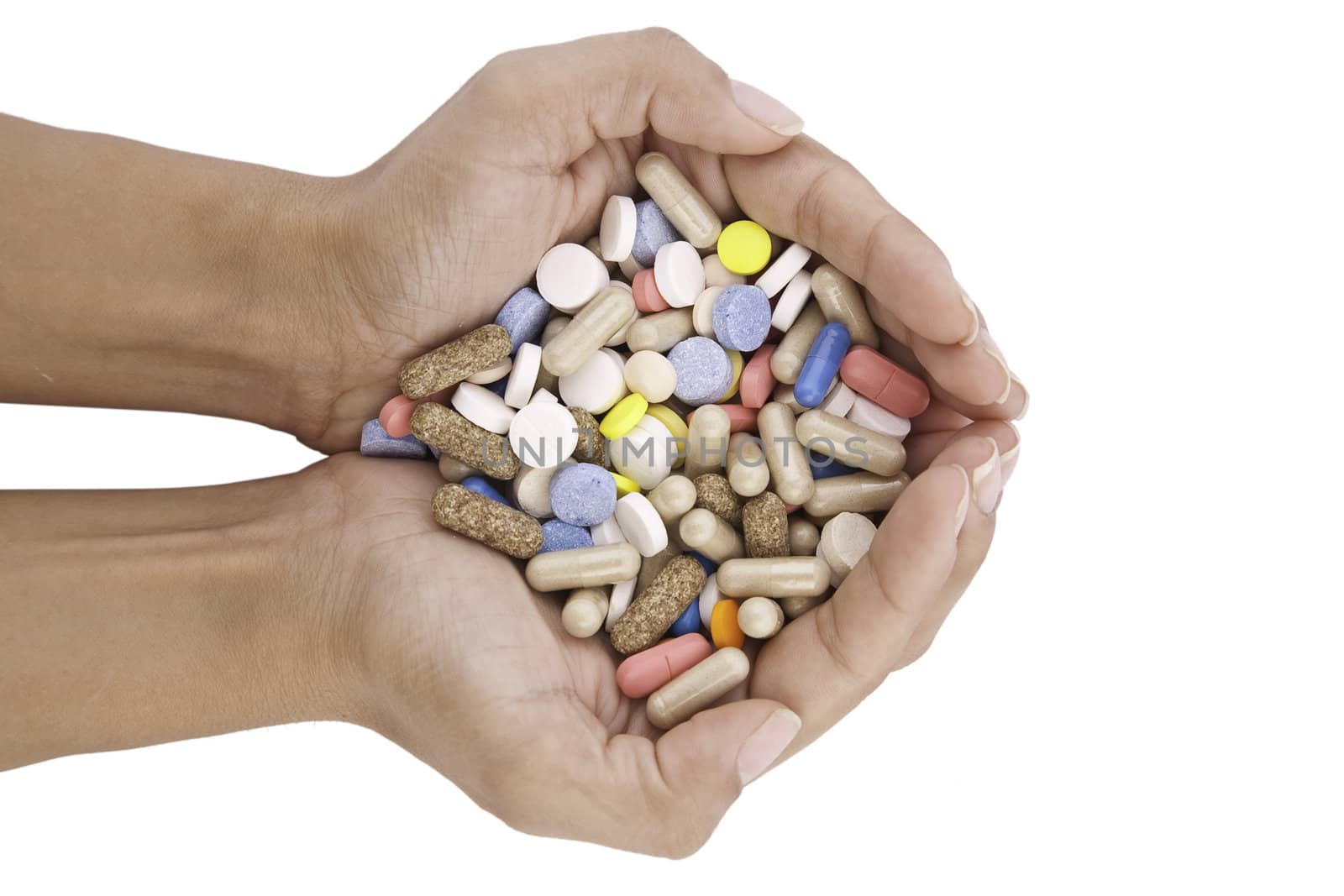 pills in hands isolated on white background