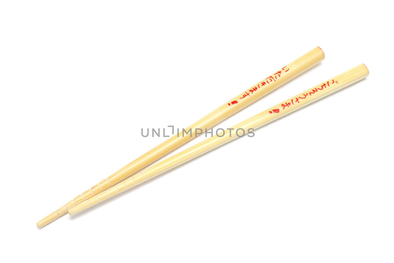 Pair of wooden chopsticks isolated on white background with words itadakimasu and gochisousama