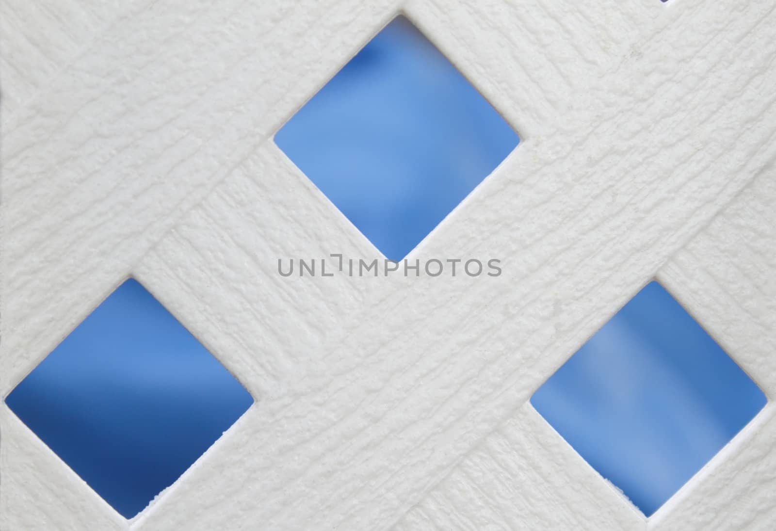 White wooden fence with blue background