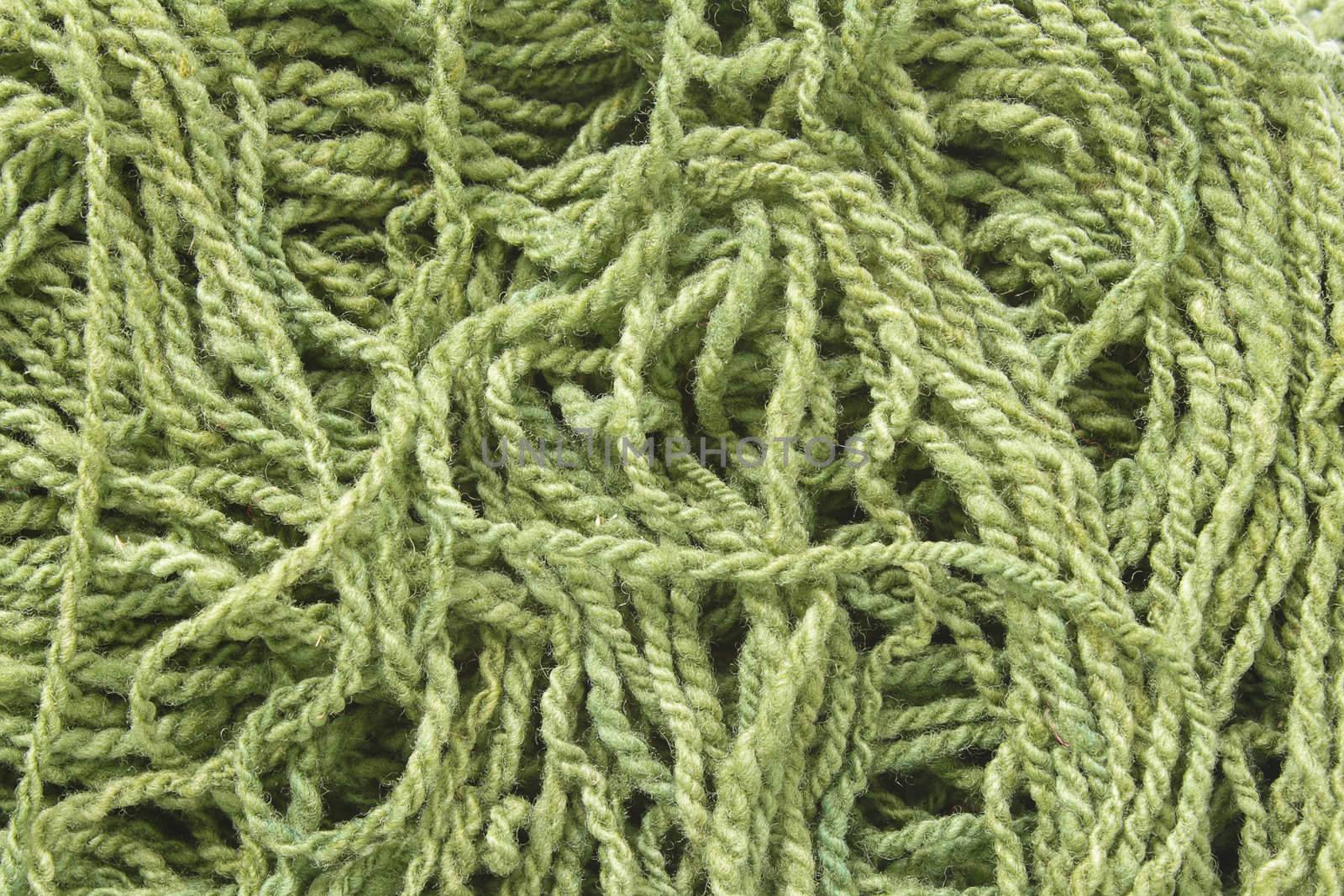 Background with green woolen yarn