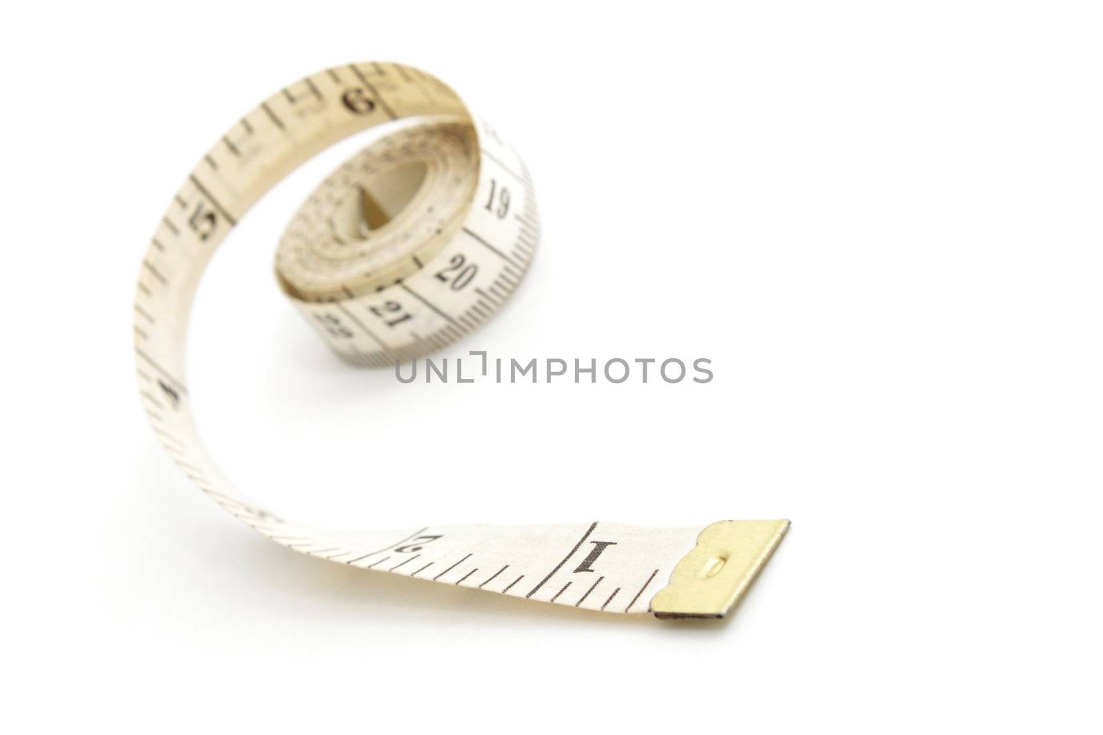 Measuring tape isolated on white background, shallow depth of field
