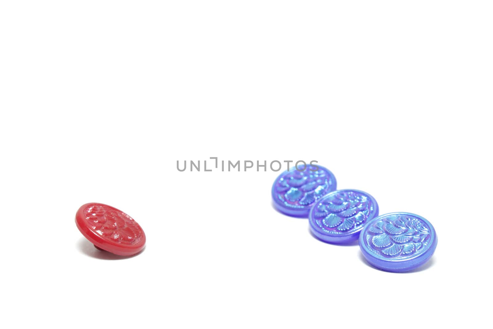 One red button and three blue ones isolated on white background