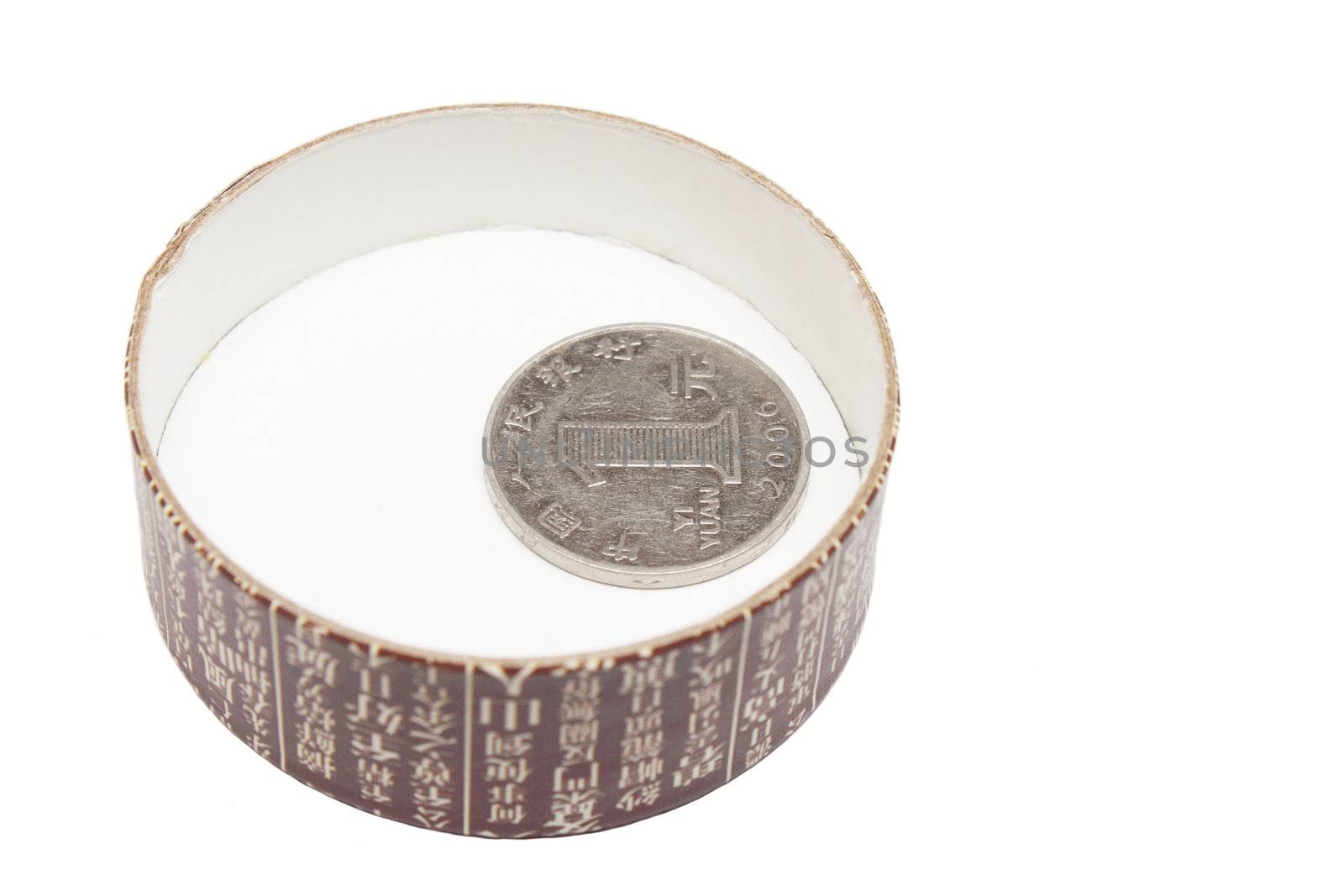 Single one yi yuan coin in the tea box cap isolated on white background