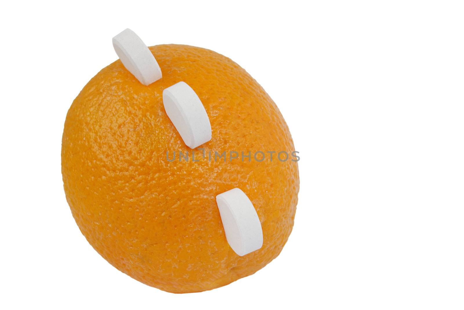 Ripe orange with three white round tablets of vitamin c isolated on white background