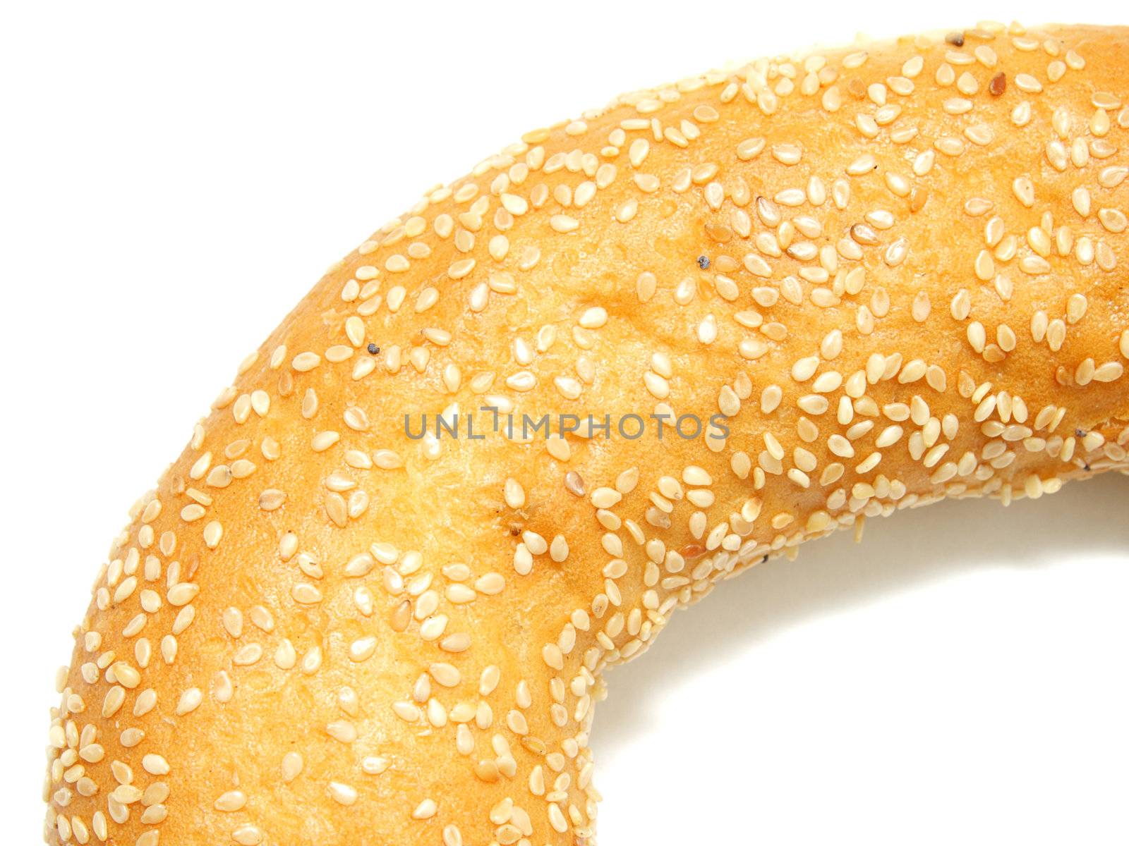 A part of bagel with sesame seeds on white by pulen