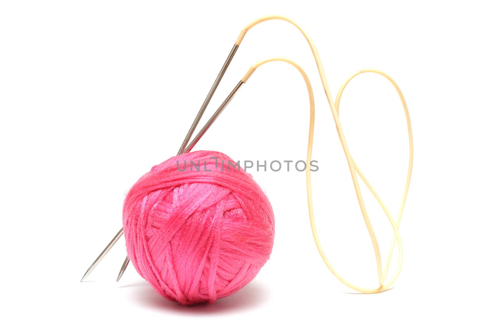 Pink clew and knitting needles isolated on white by pulen