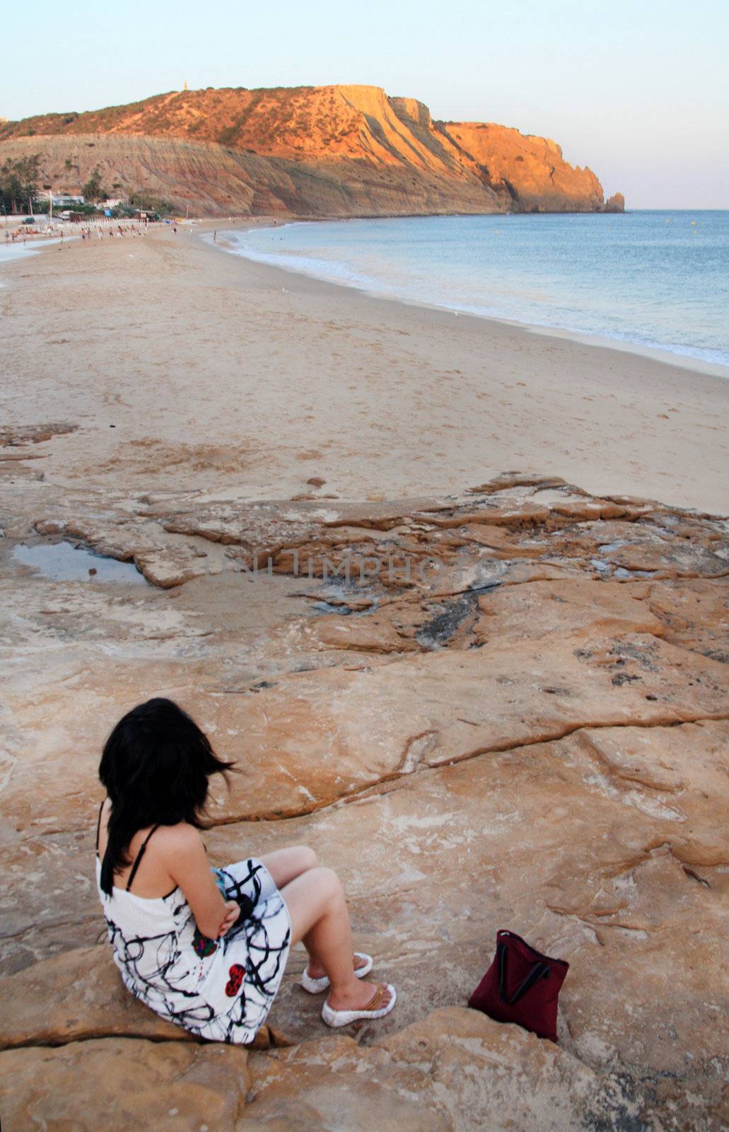 View of a young girl watching the beautiful sea.