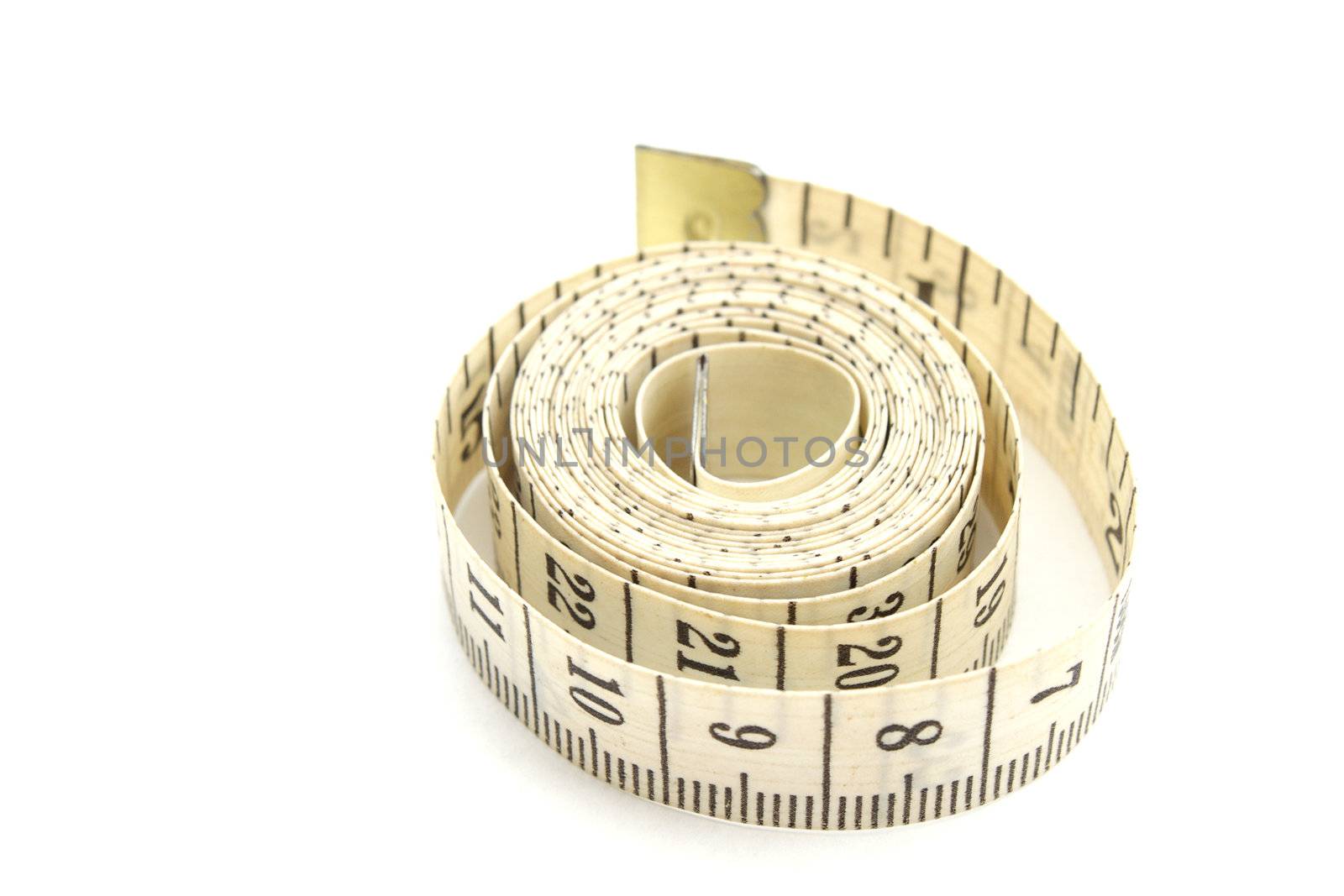 Rolled measuring tape isolated on white by pulen