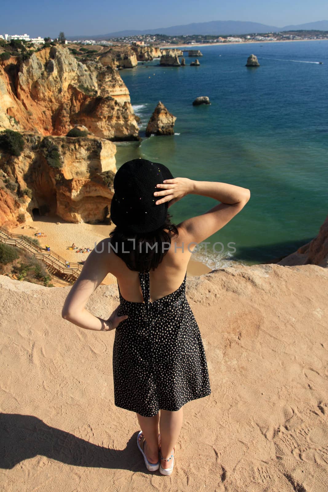 view of a beautiful woman watching the coastline near Lagos.