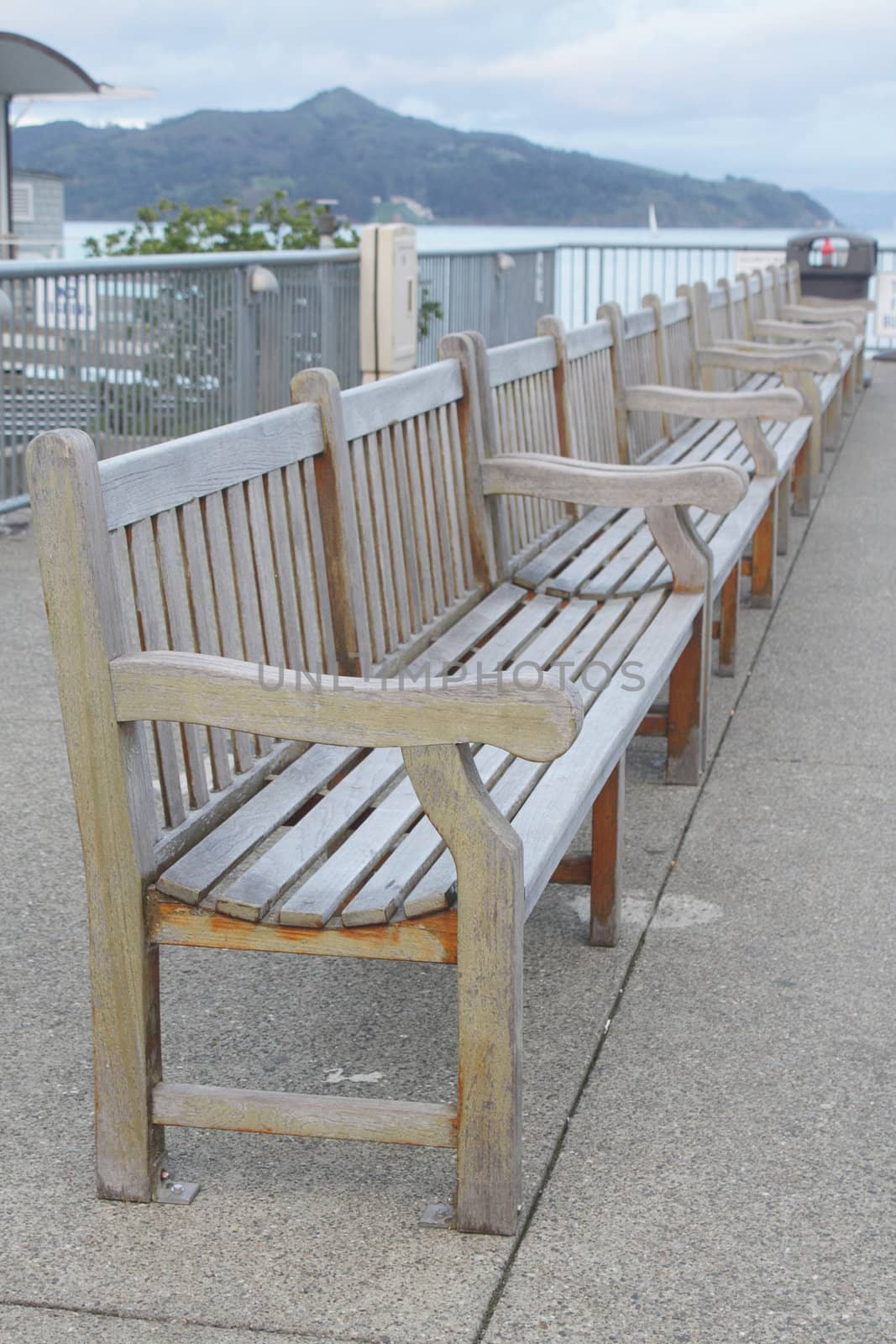 Row of wooden benches on wharf by pulen