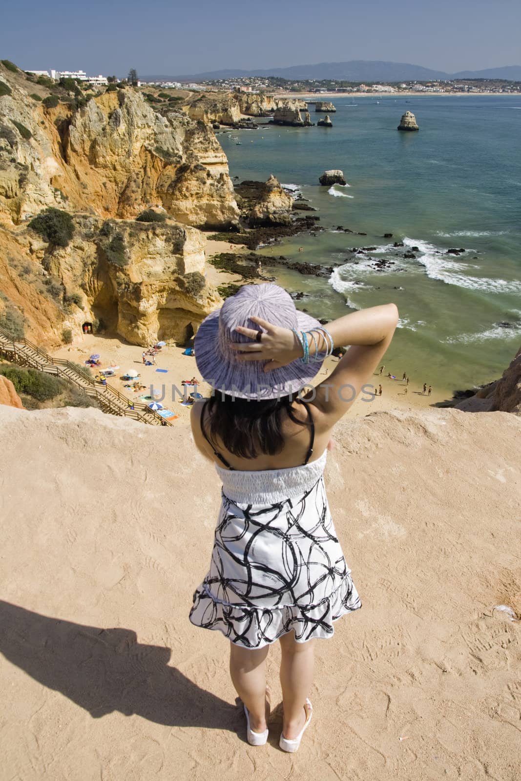 view of a beautiful woman watching the coastline near Lagos.