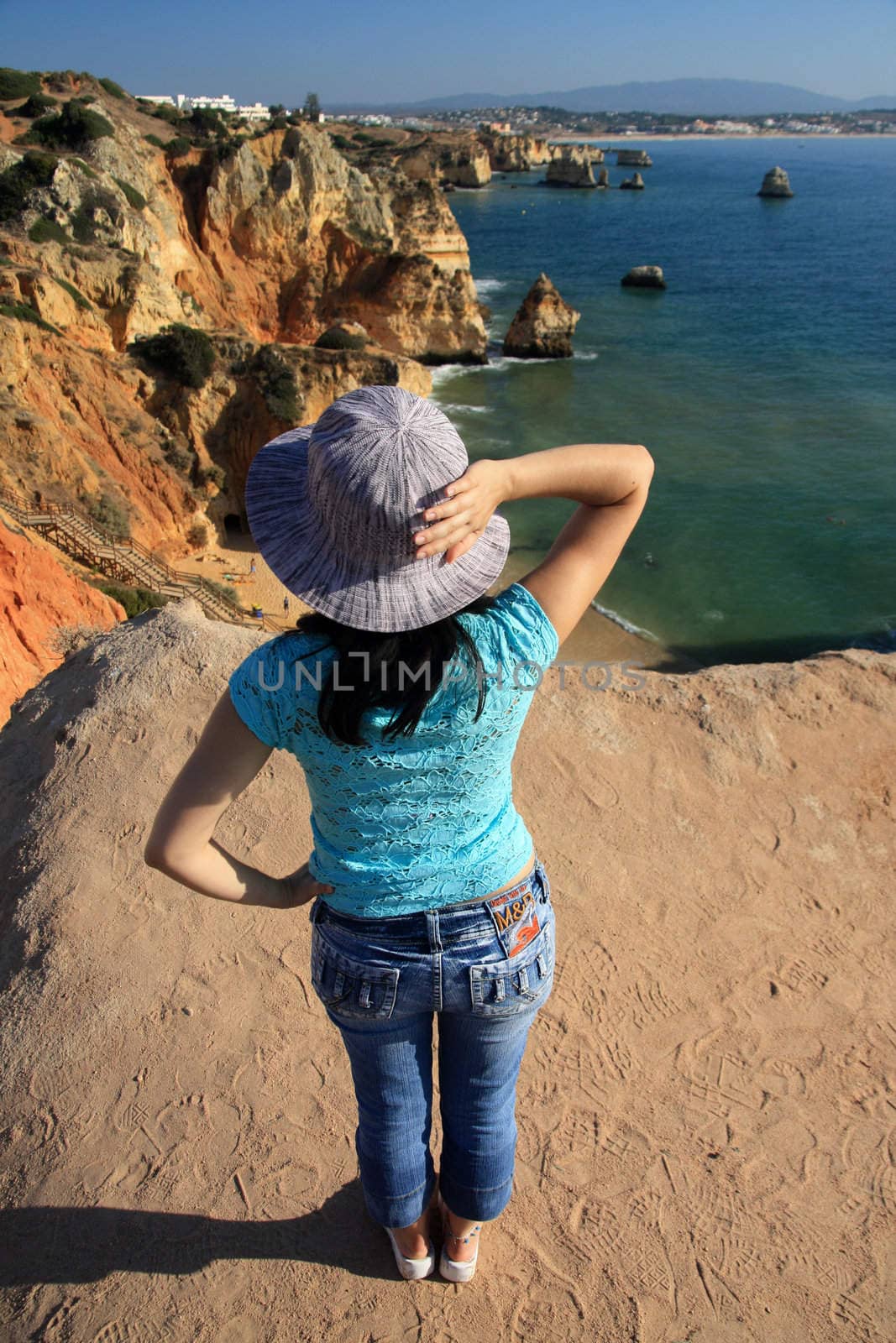 view of a beautiful woman watching the coastline near Lagos.