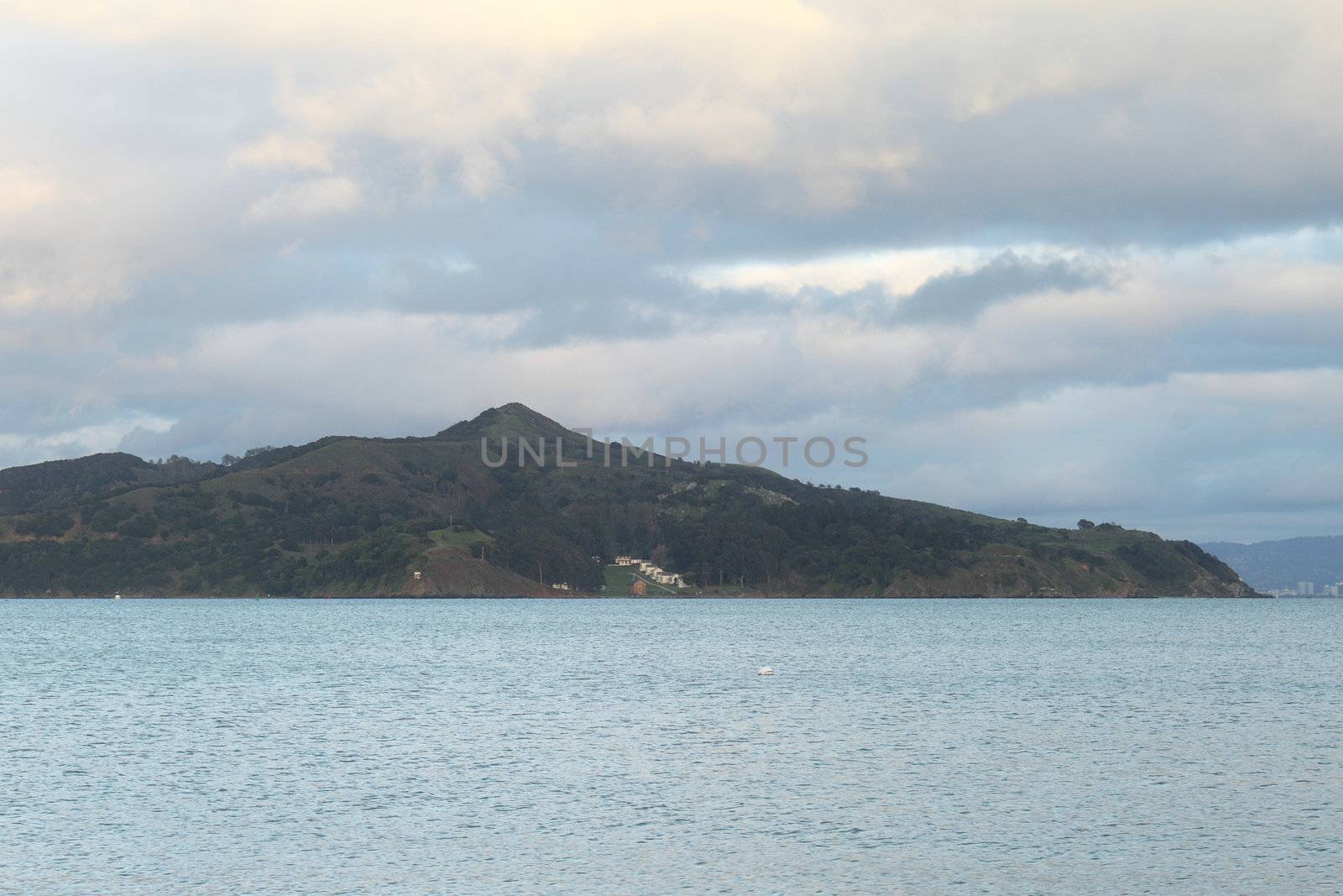 Seascape with Angel island on the horizon on a cloudy evening