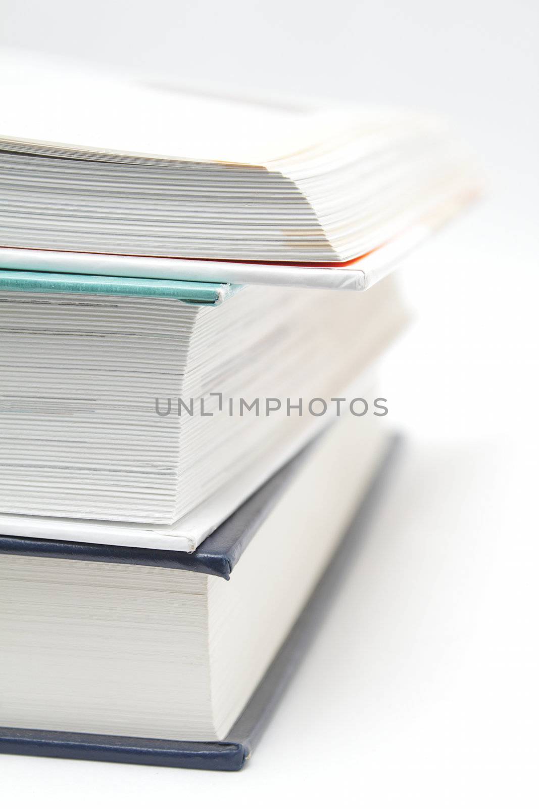 Stack of three books, upper is opened
