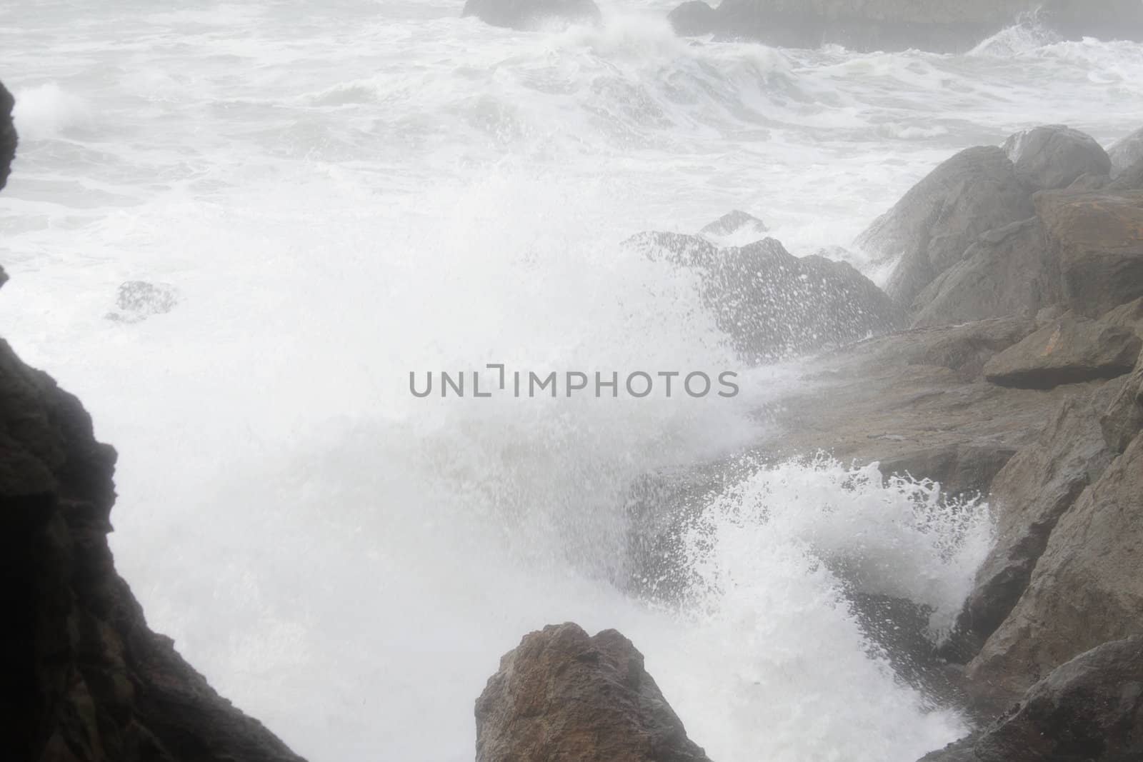 Ocean waves break over rocky coastline by pulen