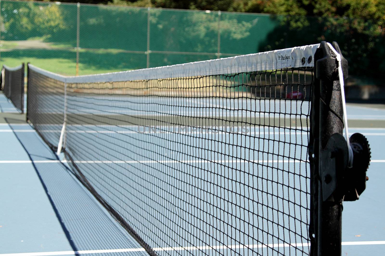 Tennis net on tennis court on a sunny day