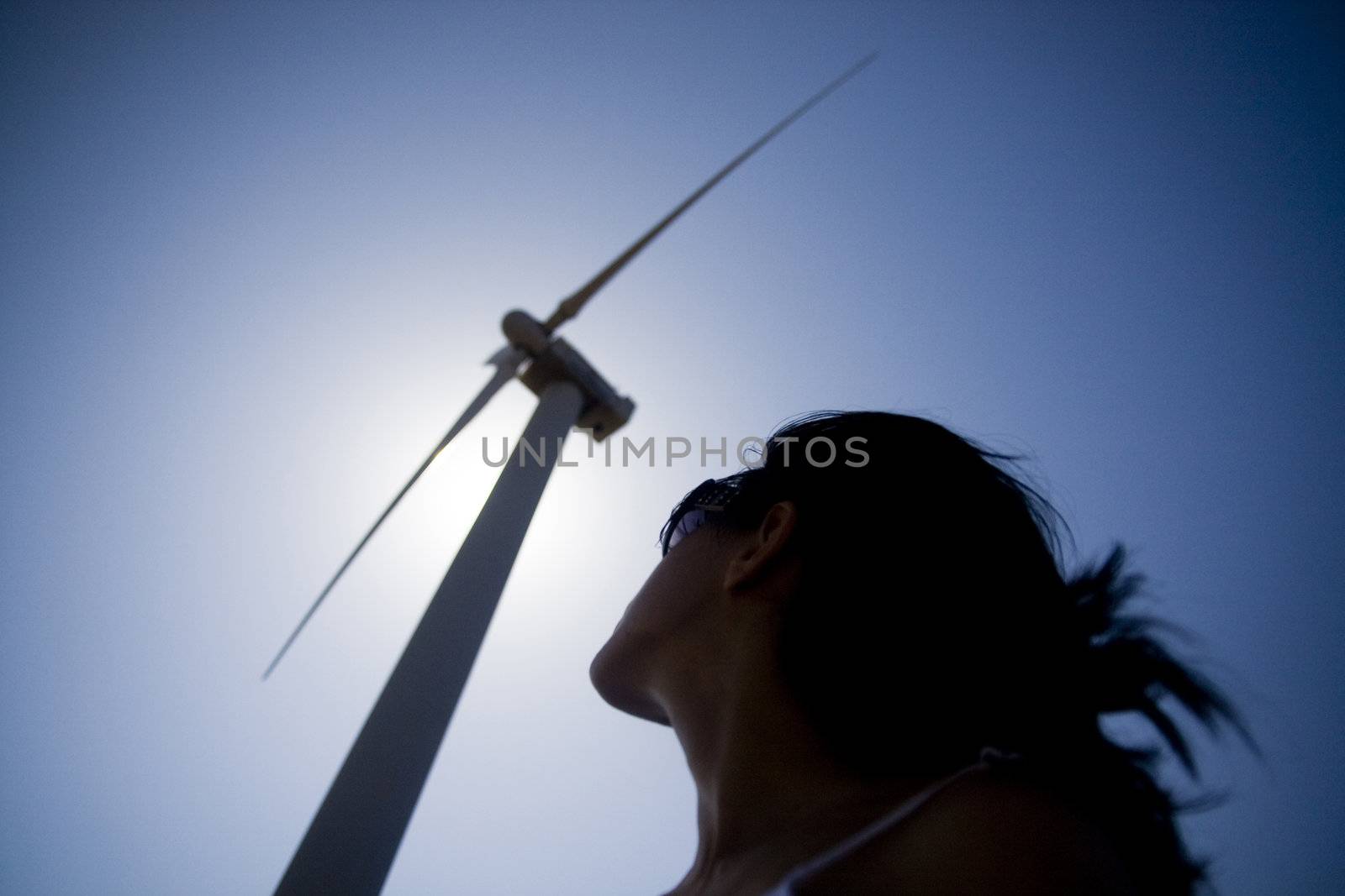 View of a young girl watching the windmill.