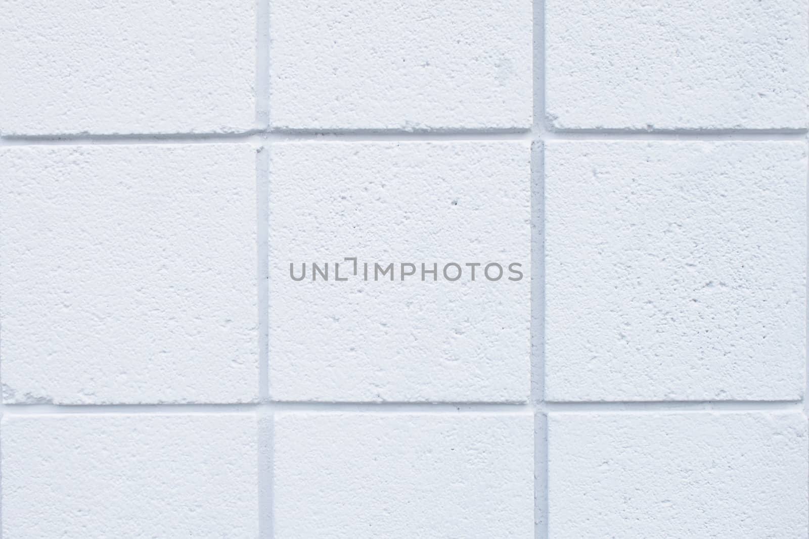 Closeup of tht white tiled wall of a house 