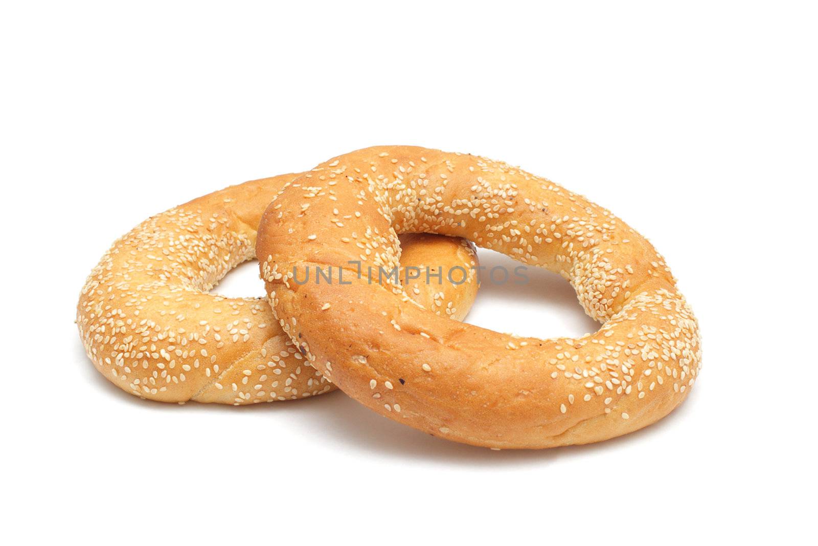 Two bagels with sesame seeds isolated on white by pulen